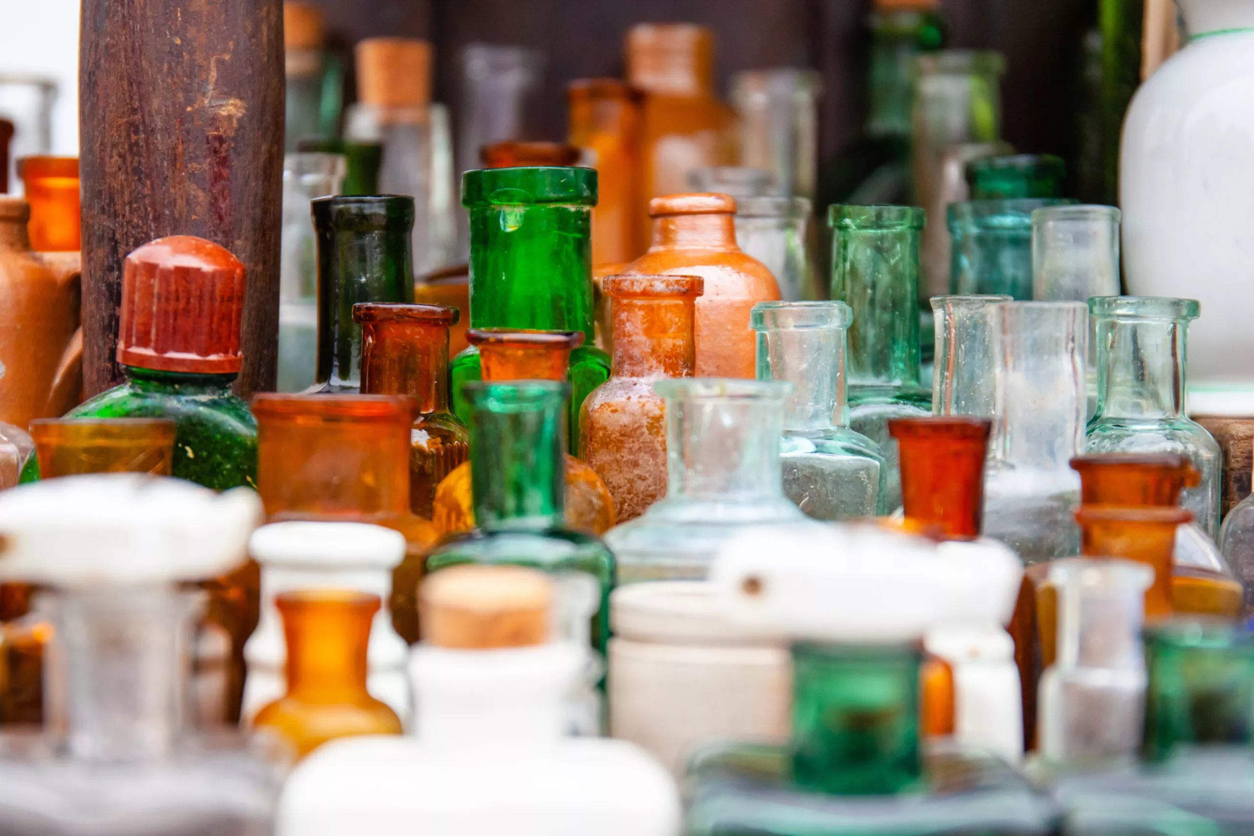 a collection of old bottles of different sizes