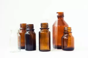 dark brown vials on white background. small empty bottles.