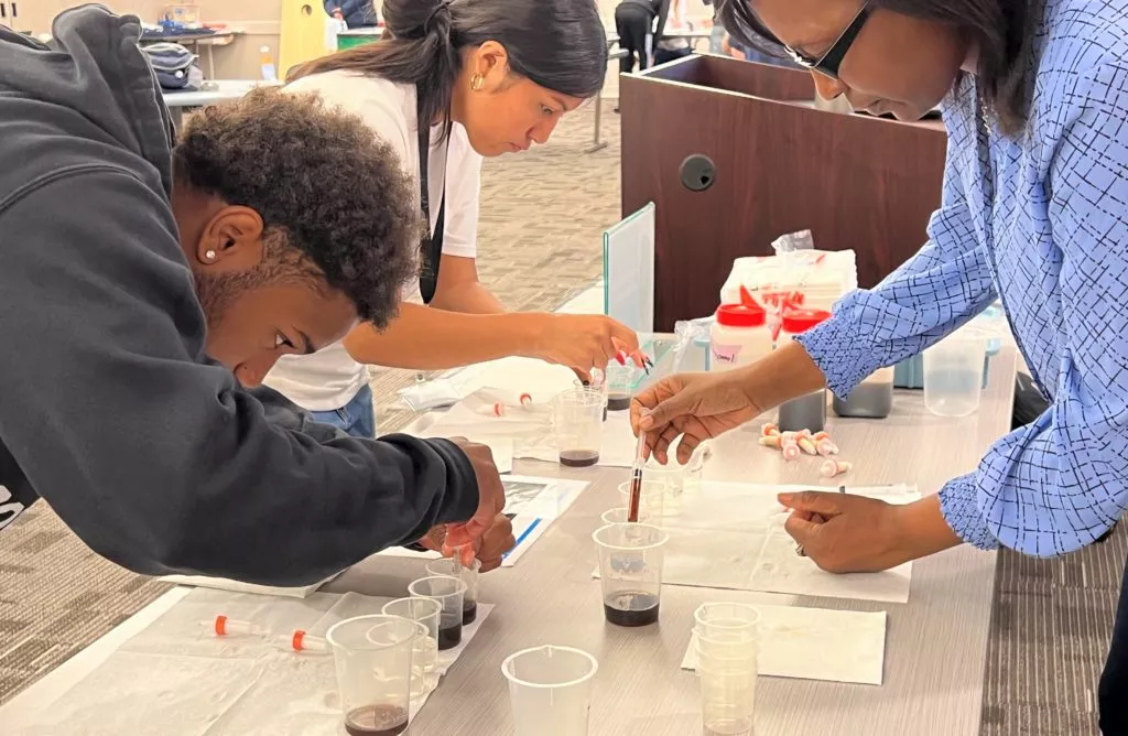 students work on science experiment at waters student academy