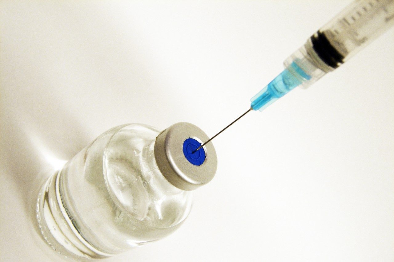 Vaccine or insulin with syringe in vial